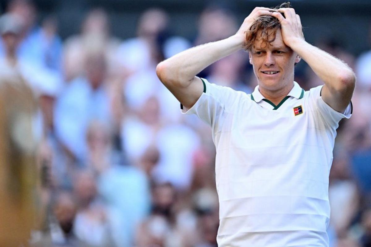 Italy's Jannik Sinner reacts to beating Germany's Alexander Zverev (R) for winning their men's singles final tennis match on the fourteenth day of the 2026 Wimbledon Championships at The All England Lawn Tennis and Croquet Club in Wimbledon, southwest London, on July 12, 2026.  Kirill KUDRYAVTSEV / AFP