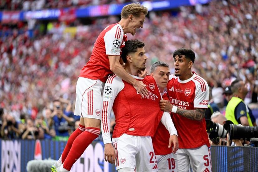 Arsenal's German forward #29 Kai Havertz (2L) celebrates after scoring the opening goal with Arsenal's Norwegian midfielder #08 Martin Odegaard (L) and teammates during the UEFA Champions League final football match between Paris Saint-Germain (PSG) and Arsenal FC at the Puskas Arena in Budapest on May 30, 2026.   INA FASSBENDER / AFP