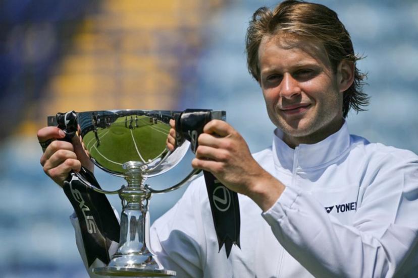 Belgium's Zizou Bergs poses with the winner's trophy after beating France's Ugo Humbert in their men's final tennis match on day seven of the Lexus Eastbourne Open at Devonshire Park, Eastbourne, on the south coast of England on June 28, 2026.  Glyn KIRK / AFP