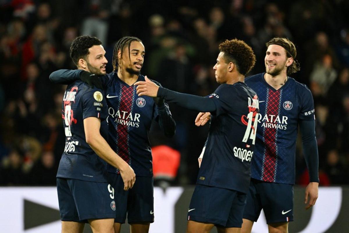 Paris Saint-Germain's French forward #29 Bradley Barcola (C-L) celebrates after scoring his team's second goal with Paris Saint-Germain's Portuguese forward #09 Goncalo Ramos (L), Paris Saint-Germain's French midfielder #14 Desire Doue (C-R) and Paris Saint-Germain's Ukrainian defender #06 Illia Zabarnyi (R) during the French L1 football match between Paris Saint-Germain (PSG) and FC Metz at the Parc des Princes stadium in Paris on February 21, 2026.  Bertrand GUAY / AFP