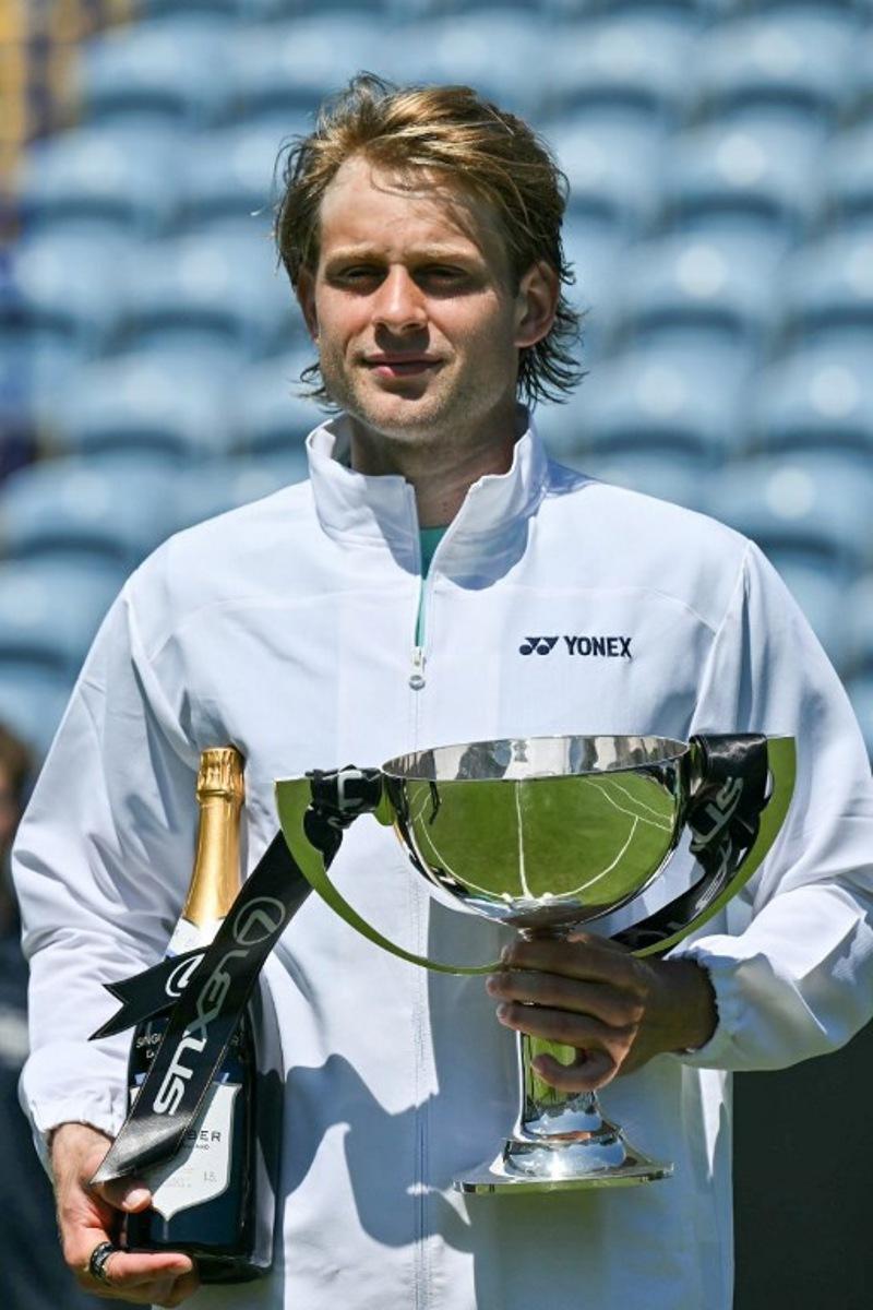 Belgium's Zizou Bergs poses with the winner's trophy after beating France's Ugo Humbert in their men's final tennis match on day seven of the Lexus Eastbourne Open at Devonshire Park, Eastbourne, on the south coast of England on June 28, 2026.  Glyn KIRK / AFP