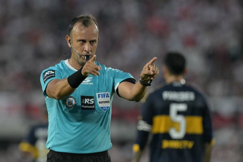 Argentine referee Dario Herrera gestures during the Argentine Professional Football League 2026 Apertura Tournament match between River Plate and Boca Juniors at MAS Monumental stadium in Buenos Aires on April 19, 2026.  JUAN MABROMATA / AFP