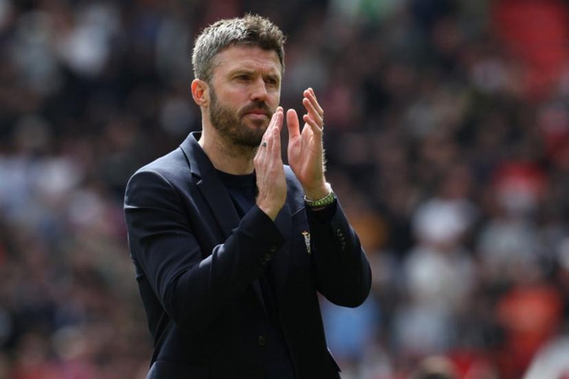 Manchester United's English Interim head coach Michael Carrick applauds fans on the pitch after their final home appearance in the English Premier League football match between Manchester United and Nottingham Forest at Old Trafford in Manchester, north west England, on May 17, 2026. United won the game 3-2. Darren Staples / AFP