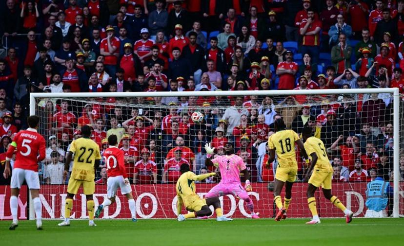 Ghana's goalkeeper #01 Lawrence Ati-Zigi saves a shot from Wales' midfielder #20 Daniel James during the international friendly football match between Wales and Ghana ahead of the 2026 FIFA World Cup football tournament, at Cardiff City Stadium, in Cardiff, on June 2, 2026.   Ben STANSALL / AFP
