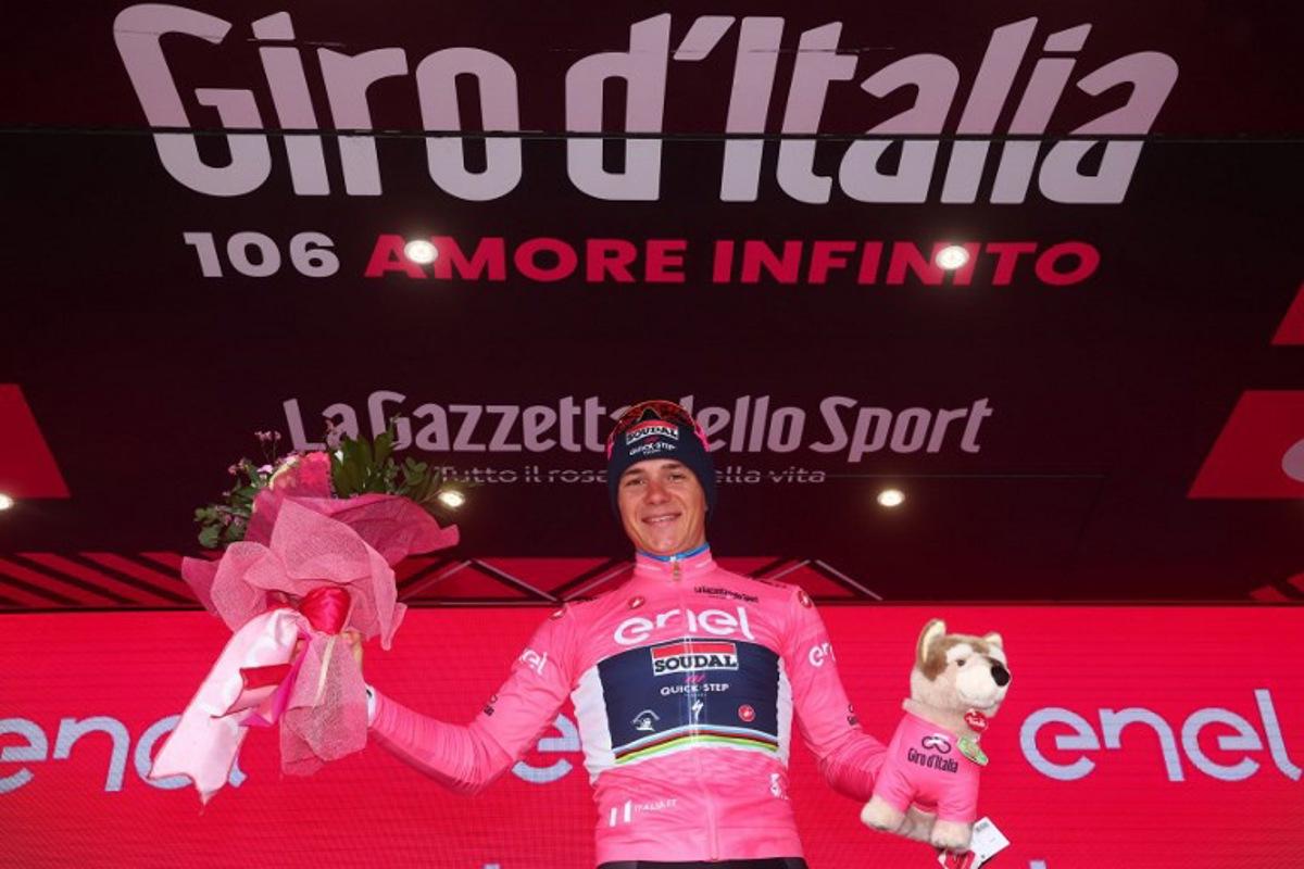 Soudal - Quick Step's Belgian rider Remco Evenepoel celebrates his overall leader's pink jersey on the podium after winning the ninth stage of the Giro d'Italia 2023 cycling race, a 35 km individual time trial between Savignano sul Rubicone and Cesena, on May 14, 2023.  Luca Bettini / AFP