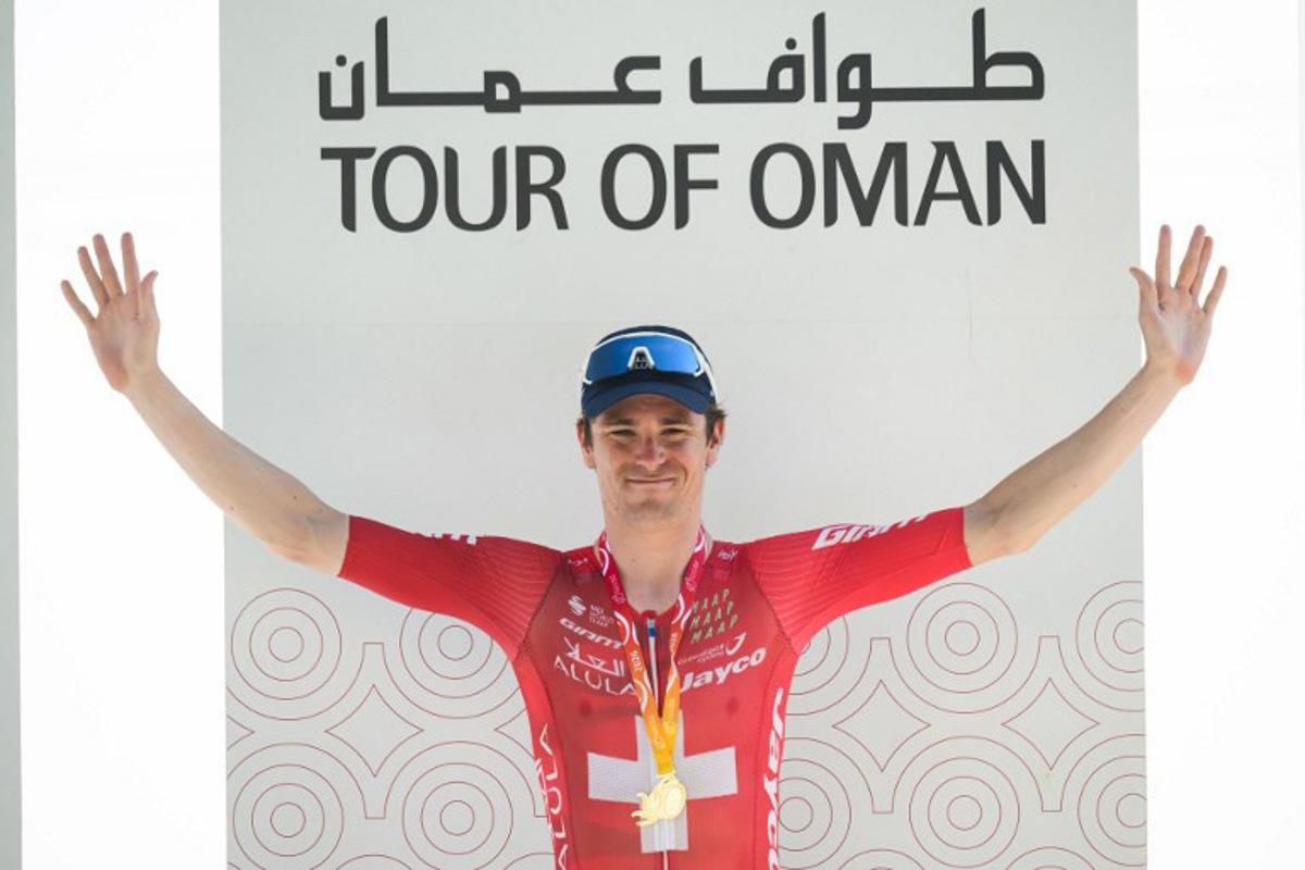 Team Jayco AlUla Swiss rider Mauro Schmid celebrates on the podium after winning the 3rd stage of the Tour of Oman cycling race from Samail "Al Fayhaa Resthouse" to Misfat Al Abriyeen, on February 9, 2026.  Loic VENANCE / AFP
