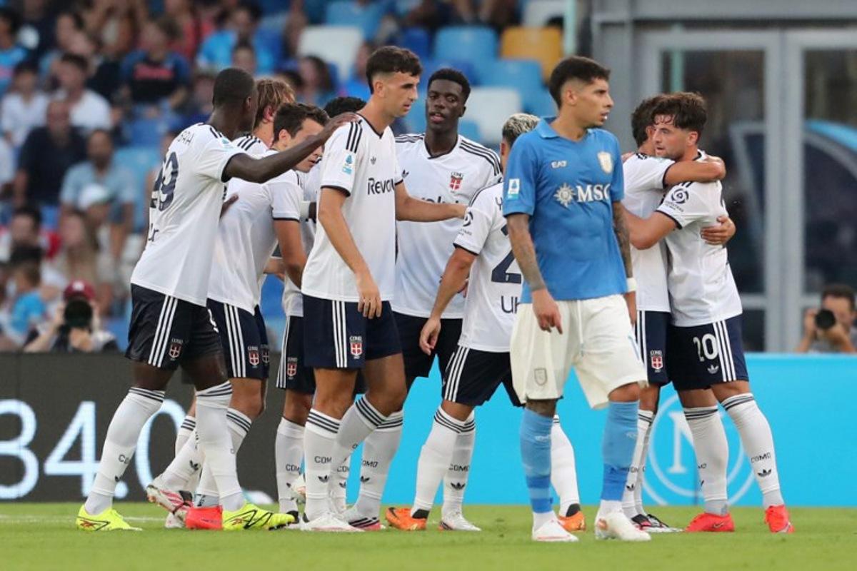 Como's Greek striker #09 Anastasios Douvikas (hidden) celebrates scoring his team's second goal during the Italian Serie A football match between Napoli and Como at the Diego Armando Maradona stadium in Naples on August 30, 2026.  Carlo Hermann / AFP
