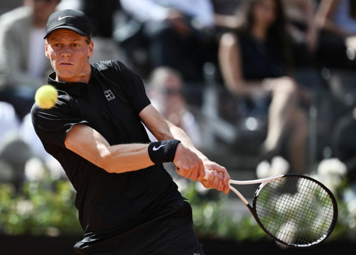 Italy's Jannik Sinner hits a return to Italy's Andrea Pellegrino during the ATP Rome Open tennis tournament at Foro Italico in Rome on May 12, 2026.   Tiziana FABI / AFP