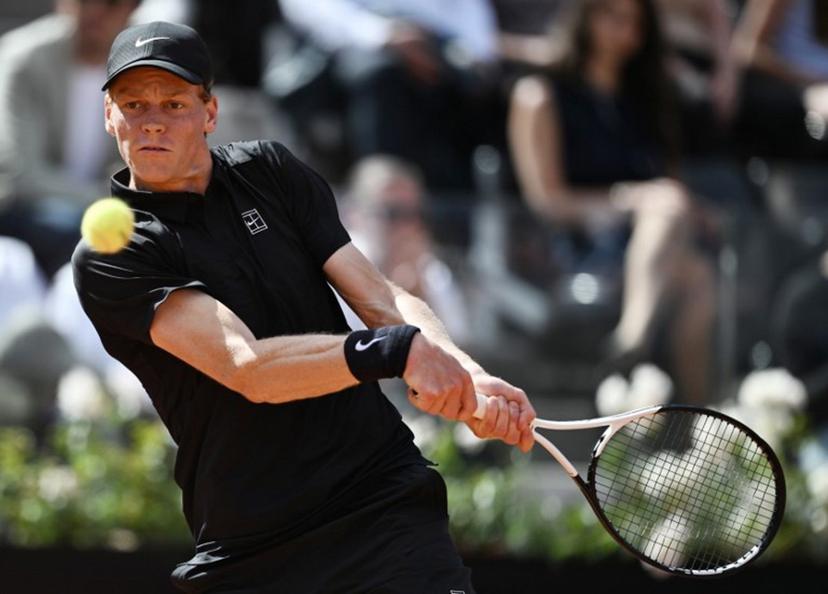 Italy's Jannik Sinner hits a return to Italy's Andrea Pellegrino during the ATP Rome Open tennis tournament at Foro Italico in Rome on May 12, 2026.   Tiziana FABI / AFP