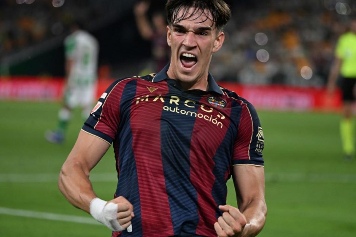 Levante's Spanish forward #19 Carlos Espi Escrihuela celebrates scoring his team's first goal during the Spanish league football match between Real Betis and Levante UD at Benito Villamarin Stadium in Seville on May 23, 2026.  CRISTINA QUICLER / AFP