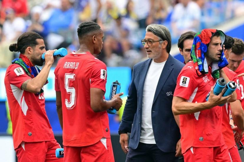 Switzerland's head coach Murat Yakin speaks to defender #05 Manuel Akanji during the cooling break of the 2026 World Cup Group B football match between Switzerland and Bosnia and Herzegovina at Los Angeles Stadium in Inglewood on June 18, 2026.   Frederic J. Brown / AFP