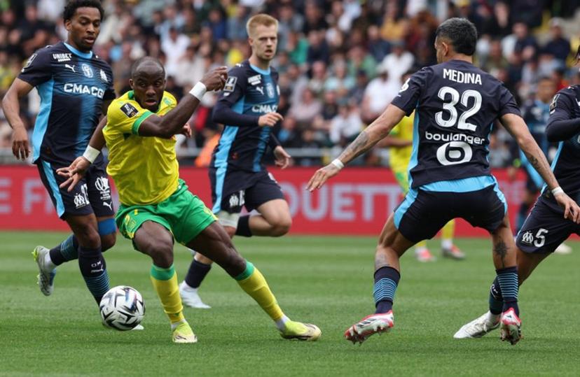 Nantes' Cameroonian forward #37 Ignatius Ganago (2nd L) fights for the ball with Marseille's Argentinian defender #32 Facundo Medina during the French L1 football match between FC Nantes and Olympique de Marseille at the Stade de la Beaujoire-Louis Fonteneau in Nantes, western France on May 2, 2026.  Fred TANNEAU / AFP