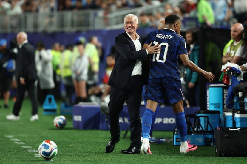 France's forward #10 Kylian Mbappe hugs head coach Didier Deschamps after being substituted during the 2026 World Cup Group I football match between France and Iraq at the Philadelphia Stadium in Philadelphia on June 22, 2026.   FRANCK FIFE / AFP