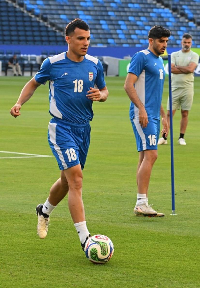 Iran's forward #18 Amirhossein Hosseinzadeh and Iran's midfielder #16 Mehdi Torabi take part in a training session at Carson Sports Park in Carson, California on June 14, 2026, on the eve of the 2026 World Cup football match between Iran and New Zealand.   Patrick T. Fallon / AFP