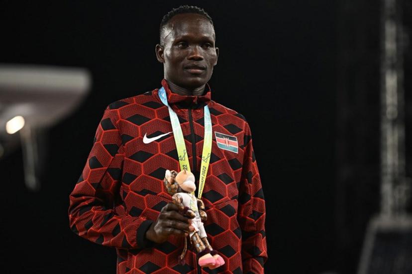 Bronze medallist Kenya's Kibiwott Kandie celebrates on the podium during the medal ceremony for the men's 10,000m athletics event at the Alexander Stadium, in Birmingham on day five of the Commonwealth Games in Birmingham, central England, on August 2, 2022.  Ben Stansall / AFP