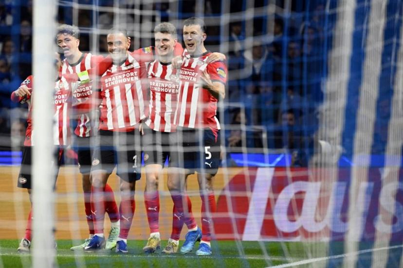 PSV Eindhoven's Dutch midfielder #20 Guus Til (2R) celebrates with teammates after scoring the opening goal during the UEFA Champions League first round day 3 football match between FC Porto and PSV Eindhoven at Dragao stadium in Porto, on October 20, 2026  Miguel RIOPA / AFP