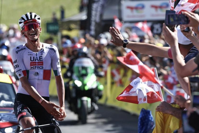 UAE Team Emirates XRG's Mexican rider Isaac Del Toro Romero celebrates as he cycles to the finish line to win the 8th and final stage of the Tour Auvergne-Rhone-Alpes cycling race (formerly known as the Criterium du Dauphine), 120,1km between Beaufort and Plateau de Solaison, in the French Alps on June 14, 2026.  Anne-Christine POUJOULAT / AFP