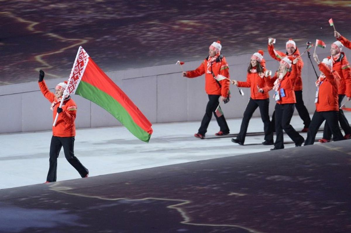 Belarus' flag bearer, freestyle skier Aleksei Grishin leads his national delegation during the Opening Ceremony of the Sochi Winter Olympics at the Fisht Olympic Stadium on February 7, 2014 in Sochi. AFP PHOTO / JONATHAN NACKSTRAND  Jonathan NACKSTRAND / AFP