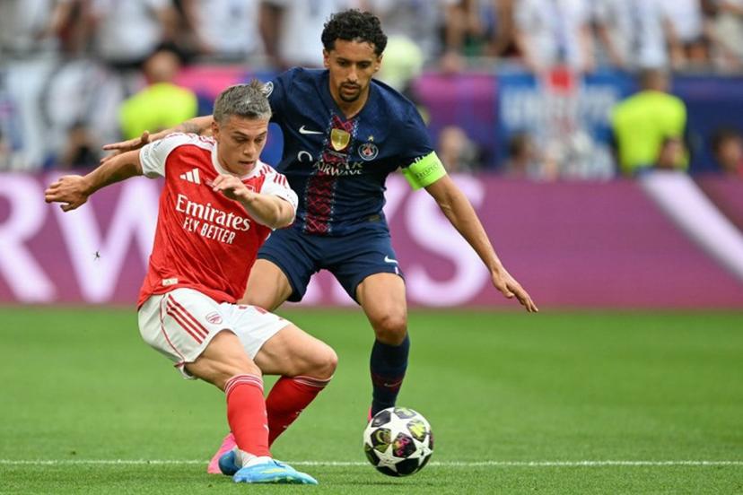 Arsenal's Belgian midfielder #19 Leandro Trossard (L) and Paris Saint-Germain's Brazilian defender #05 Marquinhos vie for the ball during the UEFA Champions League final football match between Paris Saint-Germain (PSG) and Arsenal FC at the Puskas Arena in Budapest on May 30, 2026.   NICOLAS TUCAT / AFP