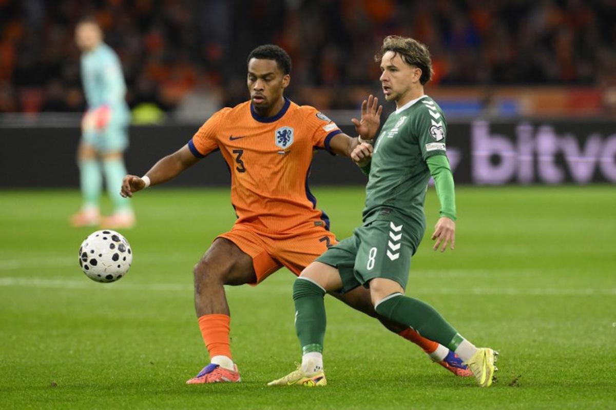 Netherlands' defender #03 Jurrien Timber (L) and Lithuania's midfielder #08 Tomas Kalinauskas (R) fight for the ball during the FIFA World Cup 2026 Group G European qualification football match between the Netherlands and Lithuania at the Johan Cruijff Arena, in Amsterdam, on November 17, 2025.  JOHN THYS / AFP