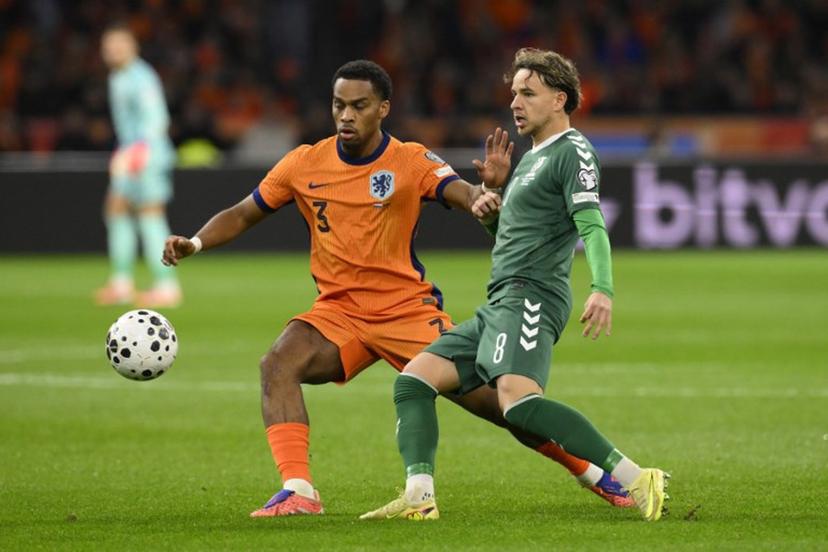 Netherlands' defender #03 Jurrien Timber (L) and Lithuania's midfielder #08 Tomas Kalinauskas (R) fight for the ball during the FIFA World Cup 2026 Group G European qualification football match between the Netherlands and Lithuania at the Johan Cruijff Arena, in Amsterdam, on November 17, 2025.  JOHN THYS / AFP