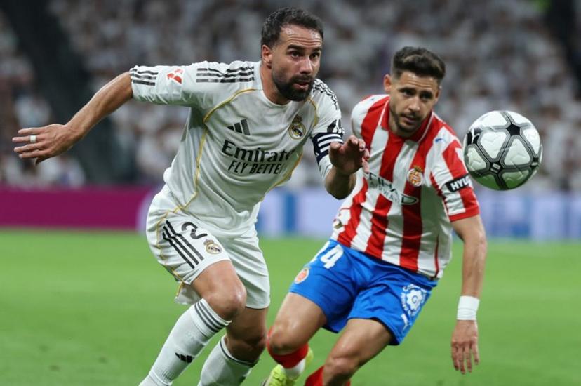 Real Madrid's Spanish defender #02 Dani Carvajal (L) vies for the ball with Girona's Spanish defender #24 Alexandre Moreno during the Spanish league football match between Real Madrid CF and Girona FC at the Santiago Bernabeu stadium in Madrid on April 10, 2026.  Thomas COEX / AFP