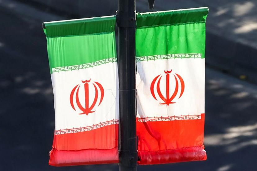 Iranian flags hang off a lamp post along a street in southern Tehran on June 20, 2026.  ATTA KENARE / AFP