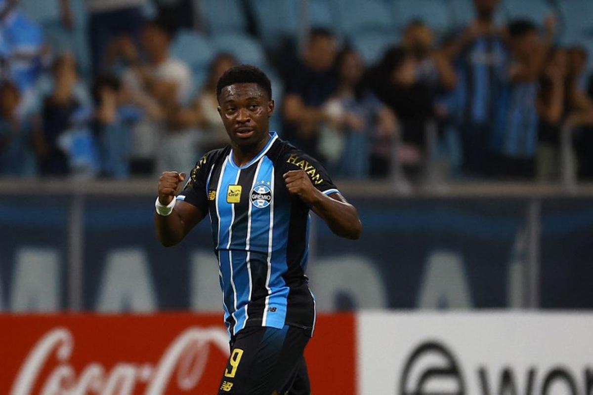 Gremio's Belgian midfielder #09 Francis Amuzu celebrates after scoring his team's first goal during the Copa Sudamericana group stage football match between Brazil's Gremio and Argentina's Deportivo Riestra at the Arena do Gremio stadium in Porto Alegre, state of Rio Grande do Sul, Brazil, on April 14, 2026.  SILVIO AVILA / AFP