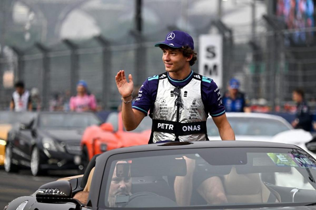 Mercedes' Italian driver Kimi Antonelli waves to the crowd during the drivers' parade before the start of the Formula One Singapore Grand Prix at the Marina Bay Street Circuit in Singapore on October 11, 2026.  ROSLAN RAHMAN / AFP