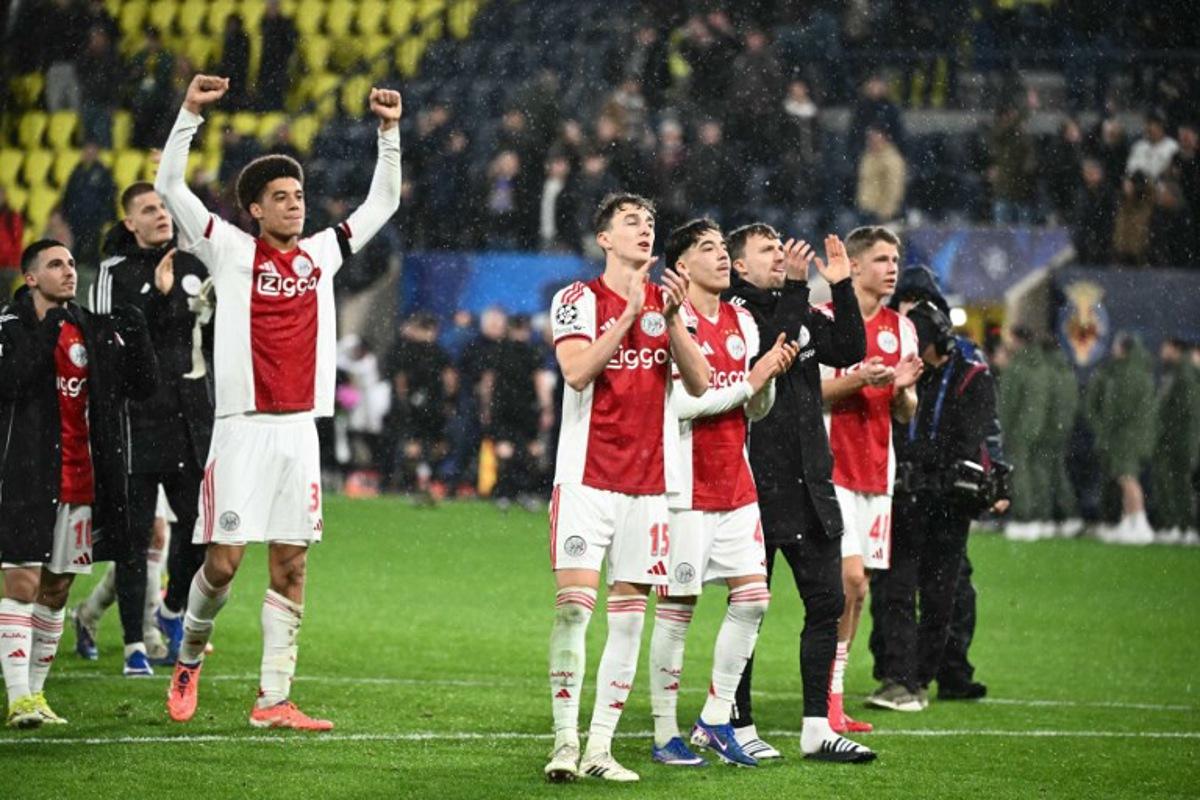 Ajax's Dutch defender #15 Youri Baas and teammates celebrate with supporters after winning the UEFA Champions League league phase day 7 football match between Villarreal CF and Ajax at La Ceramica Stadium in Vila-real on January 20, 2026.  JOSE JORDAN / AFP