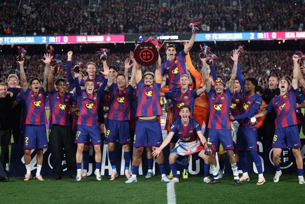 Barcelona's team celebrates winning the 2025-2026 Spanish League after the Spanish league football match between FC Barcelona and Real Madrid CF at Camp Nou Stadium in Barcelona on May 10, 2026.  Josep LAGO / AFP