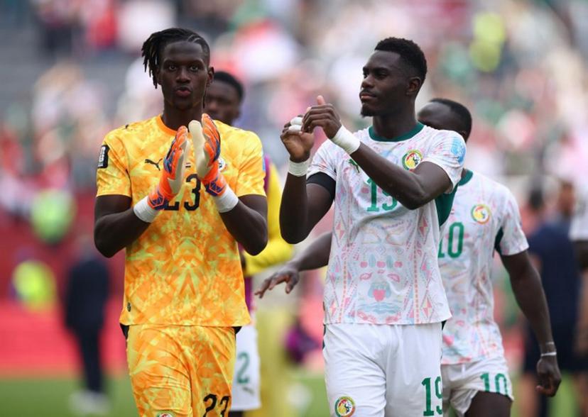 Senegal's goalkeeper #23 Mory Diaw and defender #19 Moussa Niakhate greet fans after winning the 2026 World Cup Group I football match between Senegal and Iraq at the Toronto Stadium in Toronto on June 26, 2026.   Cole Burston / AFP