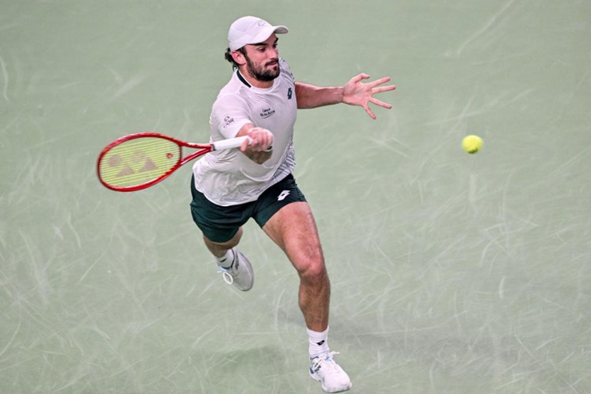 Monaco's Valentin Vacherot hits a return to USA's Tommy Paul during their men's singles match at the Shanghai Masters tennis tournament in Shanghai on October 12, 2026.  Hector RETAMAL / AFP