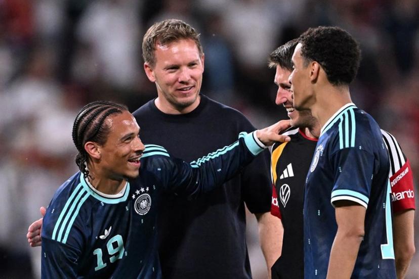 Germany's head coach Julian Nagelsmann (2L) celebrates with assistant coach Benjamin Glueck (2R) and Germany's midfielder #10 Jamal Musiala (R) and Germany's midfielder #19 Leroy Sane after their team won the friendly match between Germany and Finland ahead of the 2026 FIFA World Cup football tournament, in Mainz, western Germany on May 31, 2026. Germany won the match 4-0. Kirill KUDRYAVTSEV / AFP
