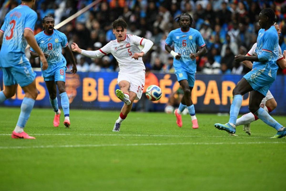 Denmark's defender #05 Joakim Maehle (C) shoots the ball during the international friendly football match between Denmark and DR Congo ahead of the 2026 FIFA World Cup football tournament at the Stade Maurice Dufrasne in Liege on June 3, 2026.  NICOLAS TUCAT / AFP