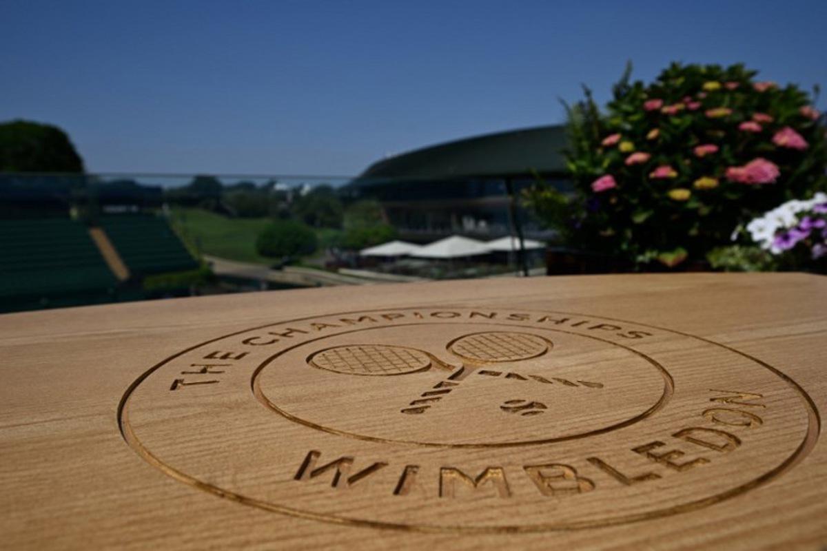A table top engraved with the Wimbledon logo is pictured at The All England Lawn Tennis and Croquet Club in Wimbledon, southwest London, on June 24, 2026, ahead of the 2026 Wimbledon Championships.  Glyn KIRK / AFP