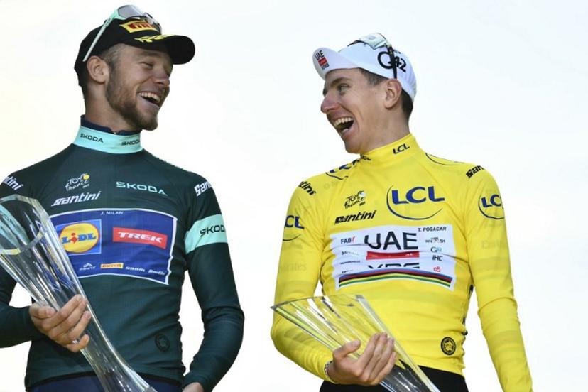 UAE Team Emirates - XRG team's Slovenian rider Tadej Pogacar wearing the overall leader's yellow jersey (R) shakes a laugh with Lidl - Trek team's Italian rider Jonathan Milan wearing the best sprinter's green jersey on the podium after the 21st and final stage of the 112th edition of the Tour de France cycling race, 132.3 km between Mantes-la-Ville and Paris Champs-Élysees, on July 27, 2025.  Marco BERTORELLO / AFP