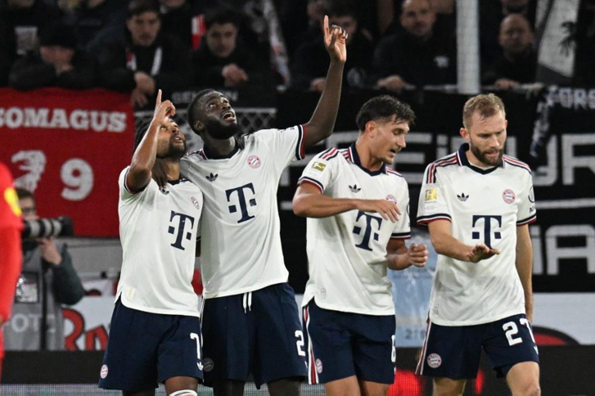 Bayern Munich's German forward #07 Serge Gnabry (L) celebrates with Bayern Munich's French defender #02 Dayot Upamecano (2nd L) after scoring the 0:2 goal during the German first division Bundesliga football match between SC Freiburg and FC Bayern Munich in Freiburg, south-western Germany, on October 25, 2026.  THOMAS KIENZLE / AFP