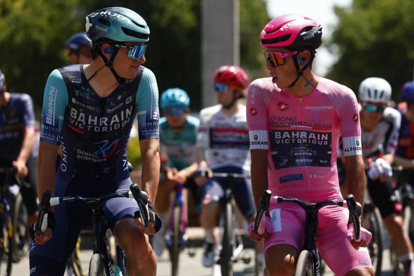 Pink jersey Bahrain - Victorious Portuguese rider Afonso Eulalio chats with teammate Bahrain - Victorious Belgian rider Alec Segaert  before the 13th stage of the Giro d'Italia 2026 - Tour of Italy cycling race between Alessandria and Verbania, Italy, on May 22, 2026.  Luca Bettini / AFP