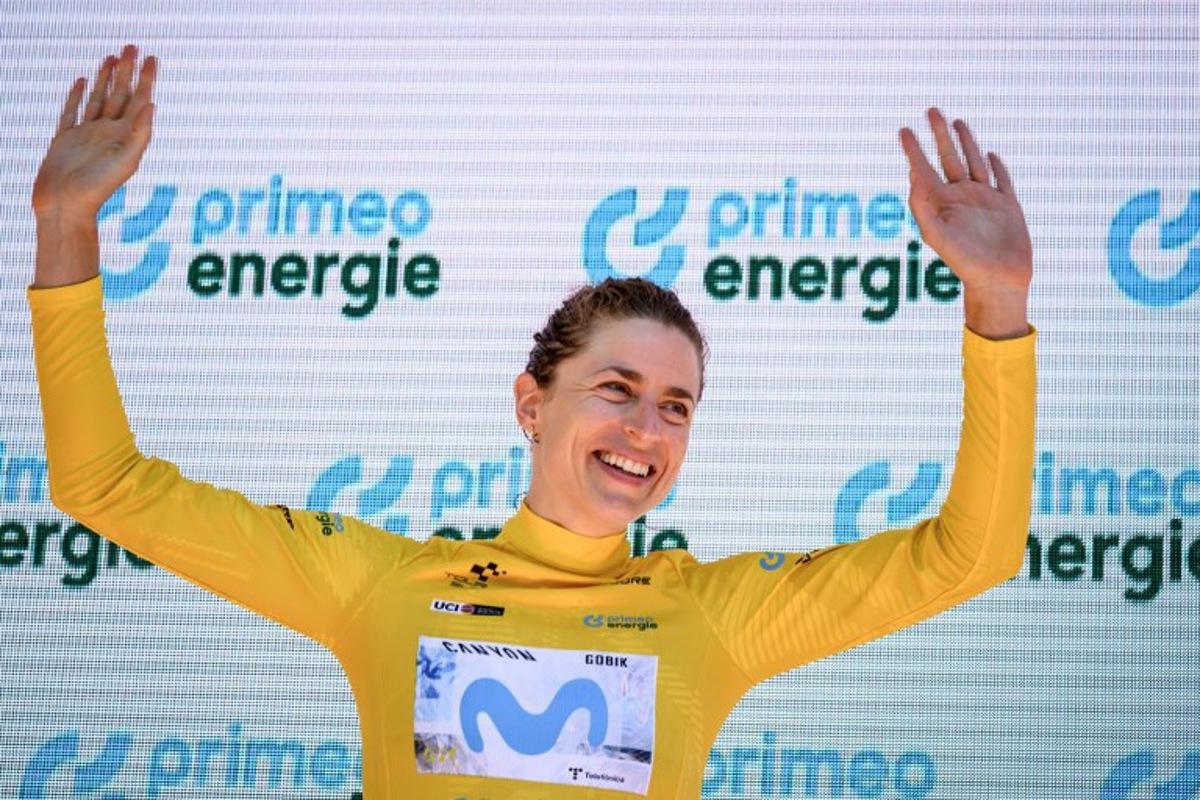 Switzerland's Marlen Reusser wearing the overall leader's yellow jersey celebrates on the podium after winning in the fourth stage, a 23,7 km time trial from Aarburg to Aarburg, at the Women's Tour of Switzerland (Tour de Suisse) cycling race in Aarburg, Switzerland, on June 20, 2026.  Fabrice COFFRINI / AFP