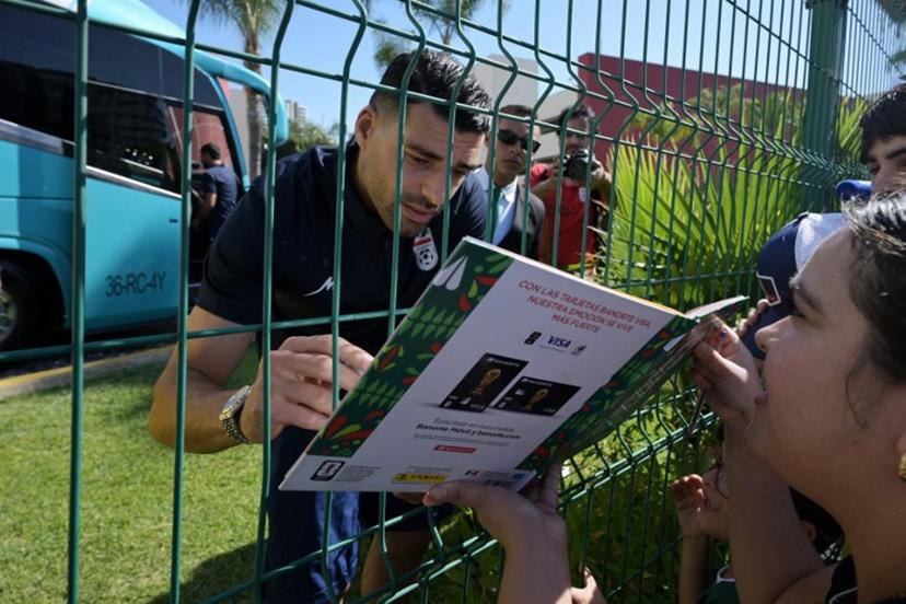 Iran's forward Mehdi Taremi signs autographs for a fan outside the Marriott Hotel before leaving for a training session in Tijuana, Mexico, on June 10, 2026, ahead of the 2026 FIFA World Cup football tournament.  Guillermo Arias / AFP
