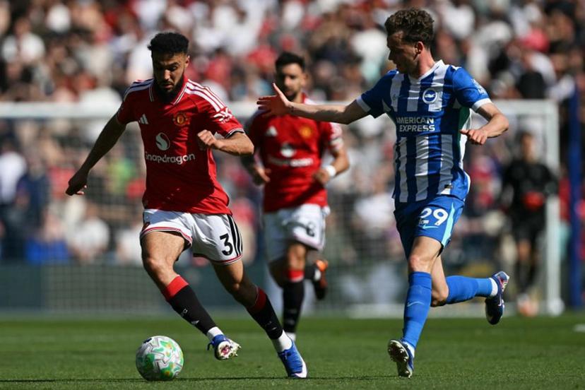 Manchester United's Moroccan defender #03 Noussair Mazraoui (L) vies for the ball with Brighton's Belgian defender #29 Maxim De Cuyper (R) during the English Premier League football match between Brighton and Hove Albion and Manchester United at the American Express Community Stadium in Brighton, southern England on May 24, 2026.  Glyn KIRK / AFP