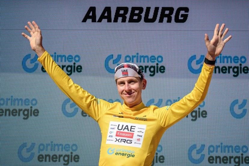 UAE Team Emirates-XRG's Slovenian rider Tadej Pogacar wearing the overall leader's yellow jersey celebrates on the podium of the fourth stage, a 23.7 km time trial from Aarburg to Aarburg, at the Men's Tour of Switzerland (Tour de Suisse) cycling race in Aarburg, Switzerland, on June 20, 2026.  Fabrice COFFRINI / AFP