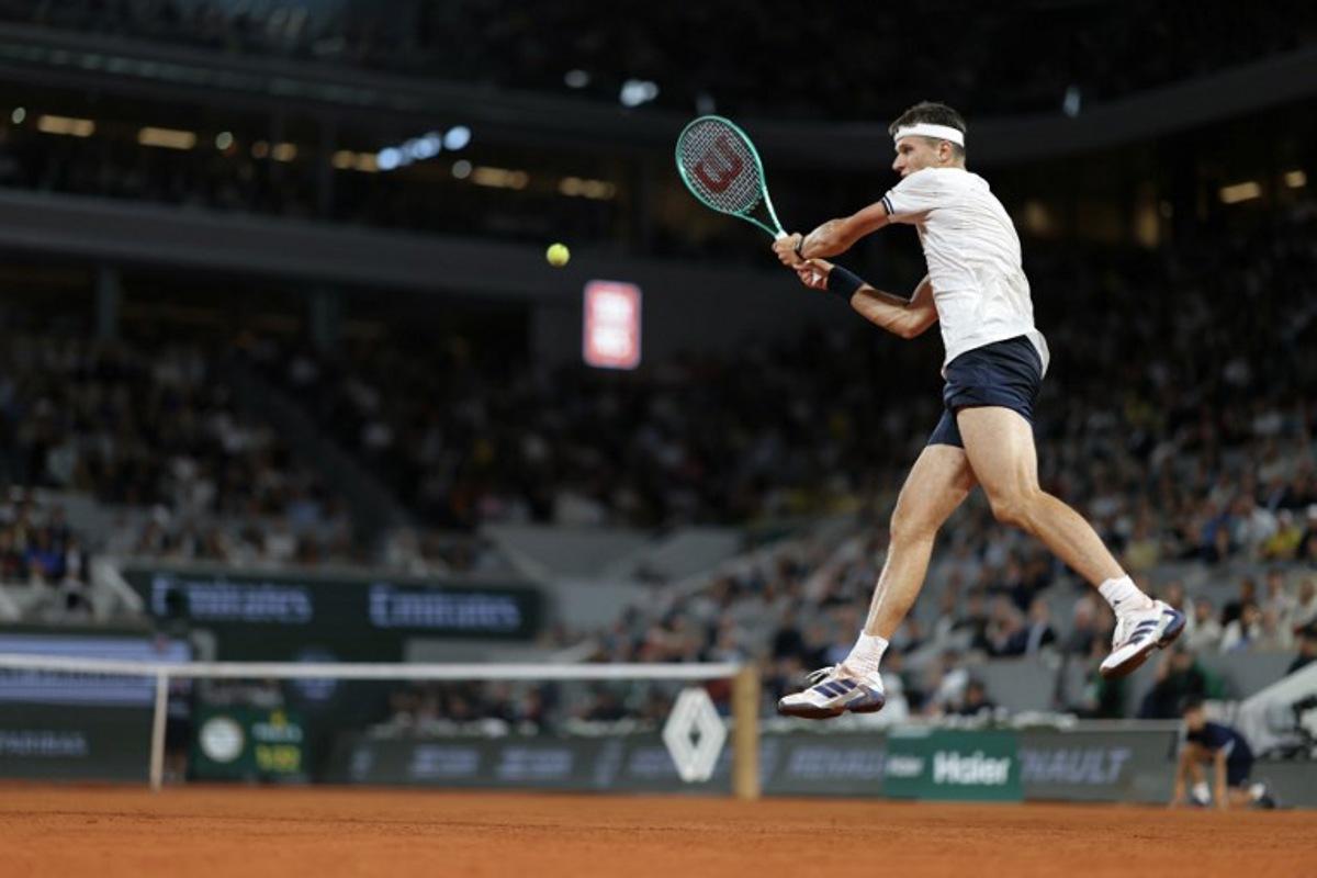 Czech Republic's Jakub Mensik plays a backhand return to Brazil's Joao Fonseca during their men's quarter final singles match on day 10 of the French Open tennis tournament on Court Philippe-Chatrier at the Roland-Garros Complex in Paris on June 2, 2026.  Thomas SAMSON / AFP