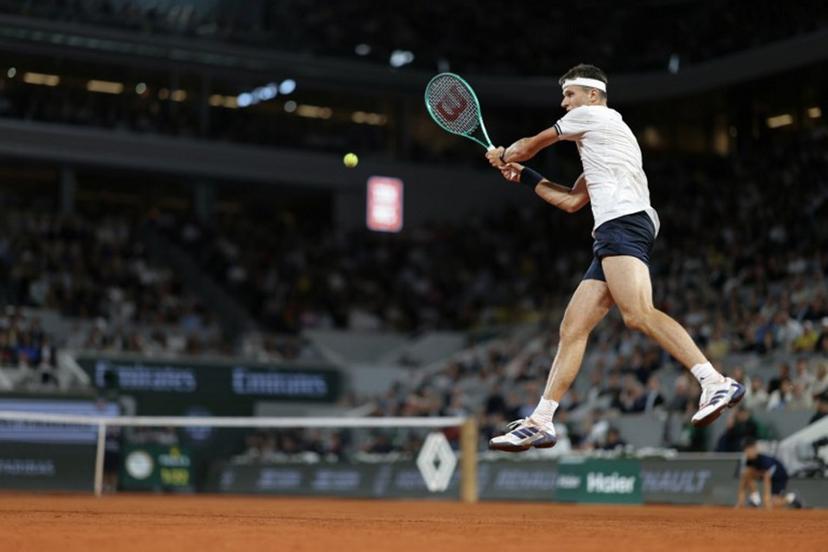 Czech Republic's Jakub Mensik plays a backhand return to Brazil's Joao Fonseca during their men's quarter final singles match on day 10 of the French Open tennis tournament on Court Philippe-Chatrier at the Roland-Garros Complex in Paris on June 2, 2026.  Thomas SAMSON / AFP