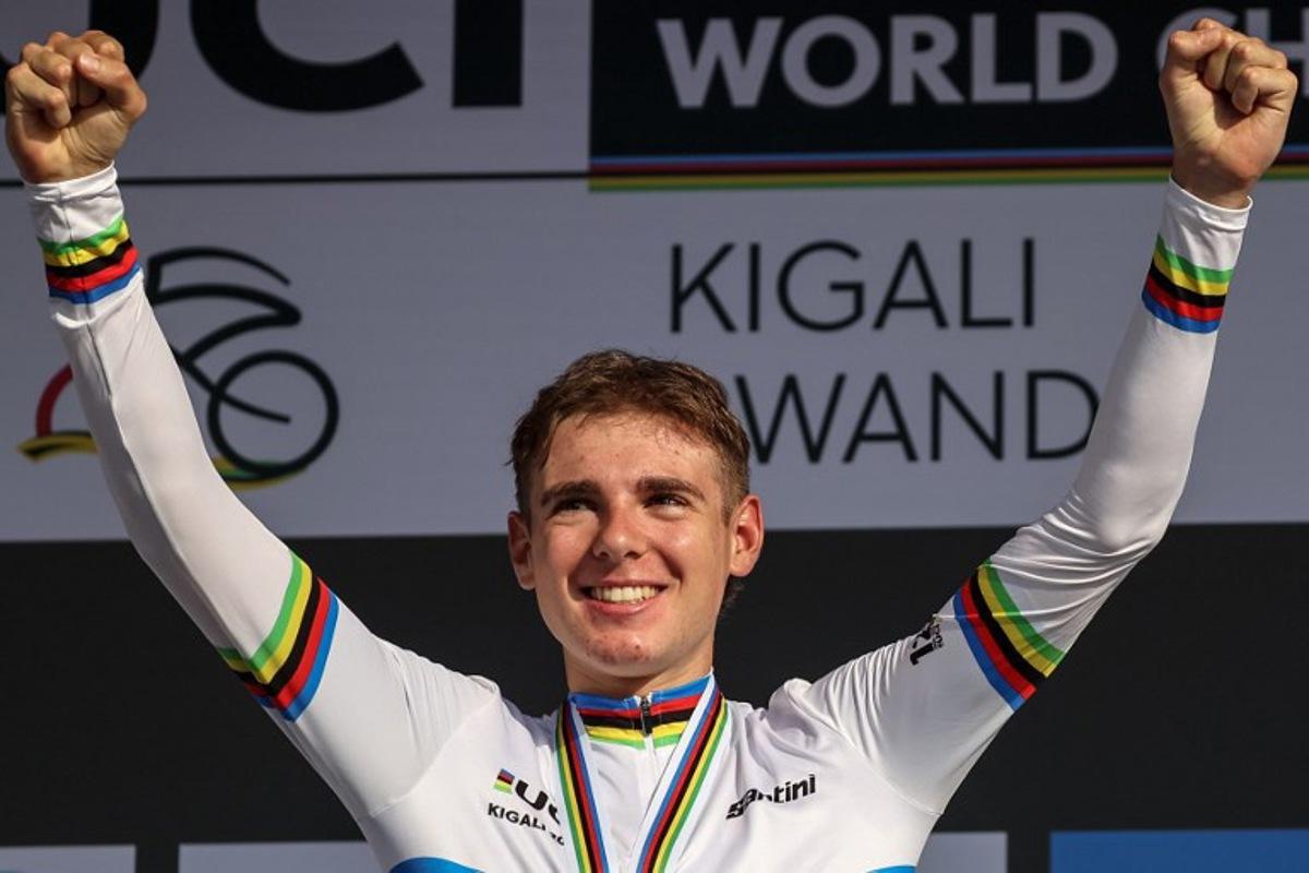 Gold medallist Italian rider Lorenzo Mark Finn celebrates on the podium following the men's U23 road race cycling event during the UCI 2025 Road World Championships, in Kigali, on September 26, 2025.  Anne-Christine POUJOULAT / AFP