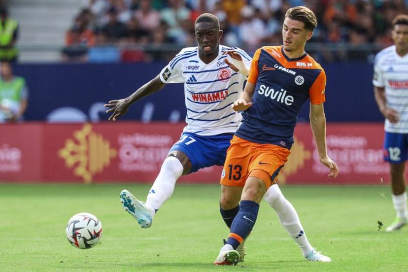 Montpellier's French midfielder #13 Joris Chotard (R) fights for the ball with Strasbourg's Senegalese midfielder #17 Pape Diong during the French L1 football match between Montpellier Herault SC and Strasbourg FC at Stade de la Mosson in Montpellier, southern France on August 18, 2024.  Pascal GUYOT / AFP