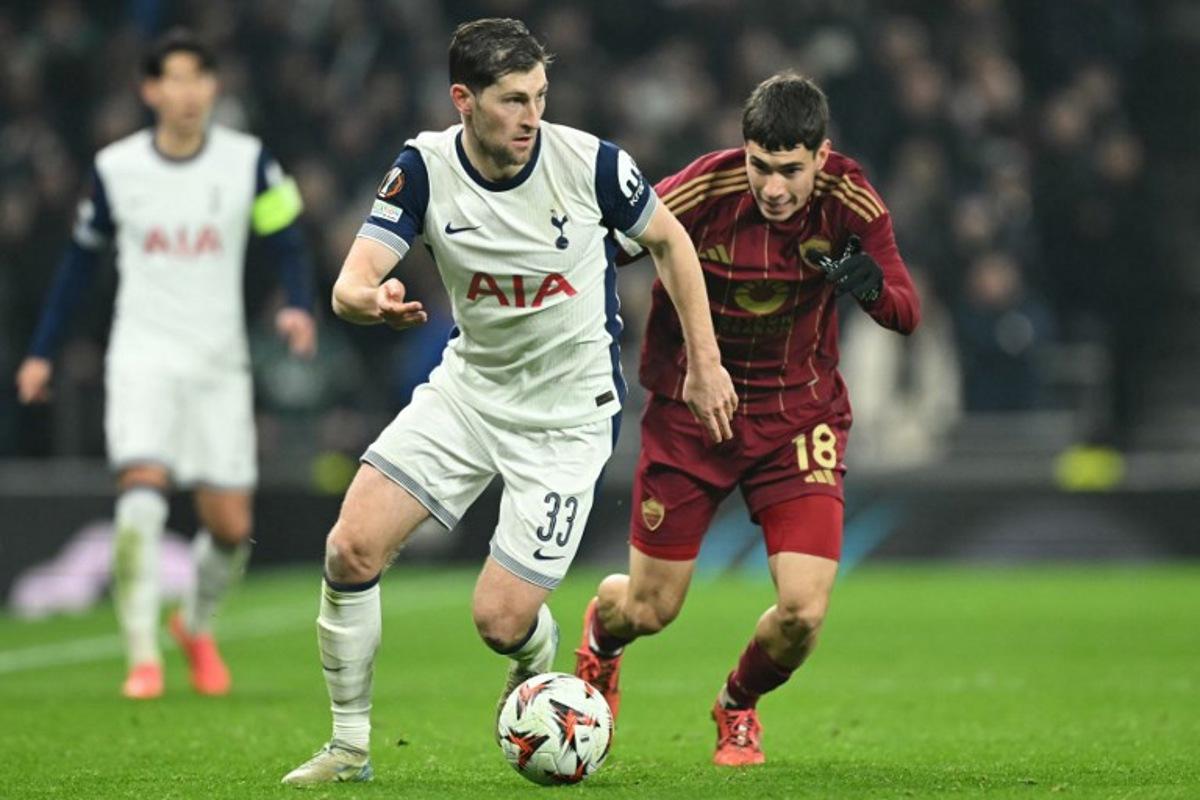 Tottenham Hotspur's Welsh defender #33 Ben Davies vies with Roma's Argentinian midfielder #18 Matias Soule (R) during the UEFA Europa League, League Phase football match between Tottenham Hotspur and Roma at the Tottenham Hotspur Stadium in London, on November 28, 2024.  JUSTIN TALLIS / AFP