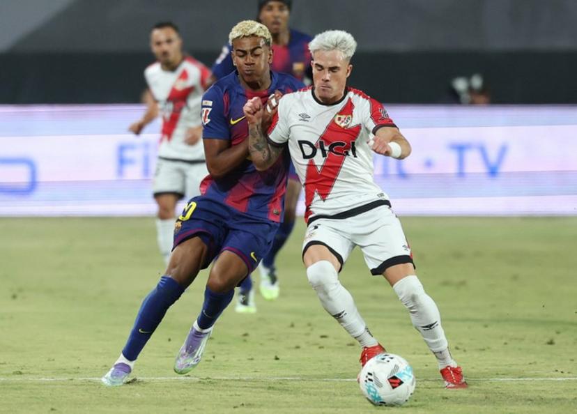 Barcelona's Spanish forward #10 Lamine Yamal fights for the ball with Rayo Vallecano's Spanish defender #03 Pep Chavarria during the Spanish league football match between Rayo Vallecano de Madrid and FC Barcelona at the Vallecas stadium in Madrid on August 31, 2025.  Pierre-Philippe MARCOU / AFP