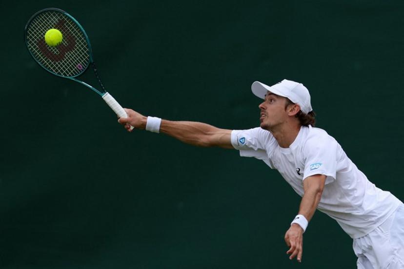 Australia's Alex De Minaur plays a forehand return to Denmark's August Holmgren during their men's singles third round tennis match on the sixth day of the 2025 Wimbledon Championships at The All England Lawn Tennis and Croquet Club in Wimbledon, southwest London, on July 5, 2025.  Adrian Dennis / AFP
